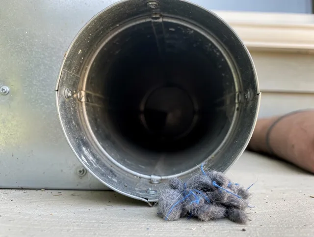 Waterbury Dryer Vent Cleaning technician using specialized equipment to clear severe dryer vent blockage in Waterbury